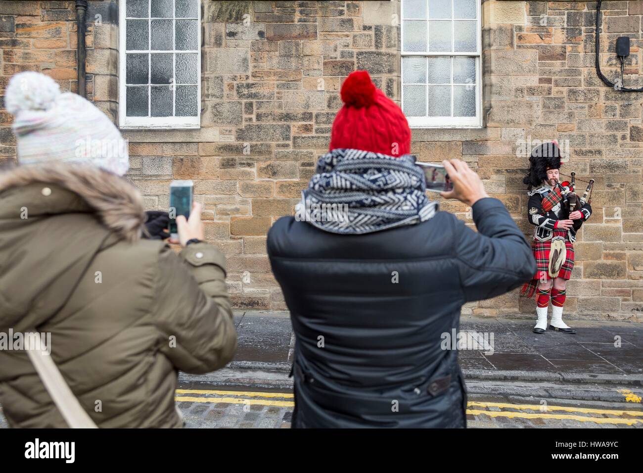 Royaume-uni, Ecosse, Edimbourg, classé au patrimoine mondial, les touristes de photographier un joueur de cornemuse sur le Royal Mile Banque D'Images