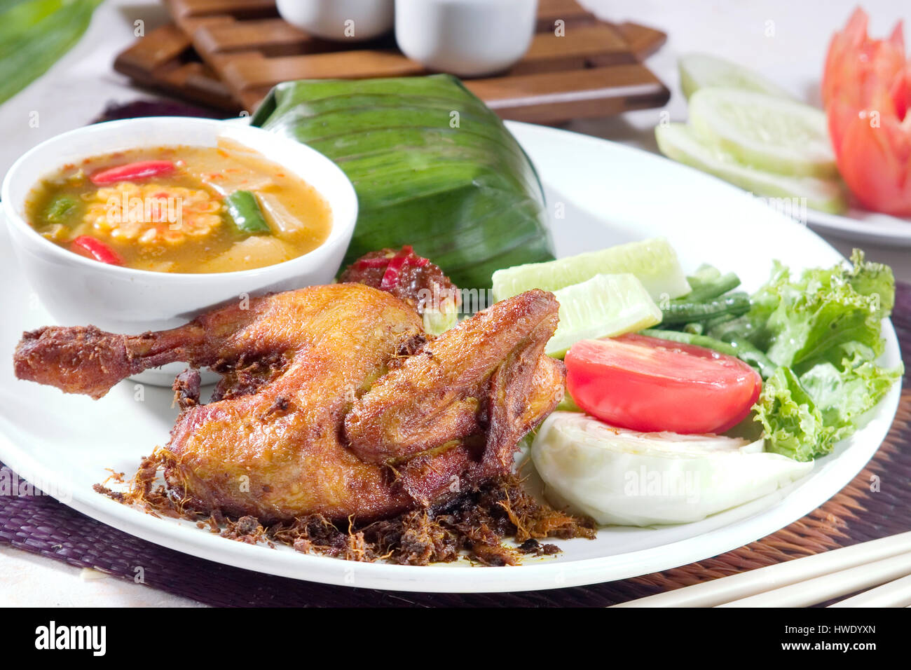 Ayam goreng Indonésie alimentaire poulet frit, servir avec un plat de tamarin, sayur asam et riz Banque D'Images