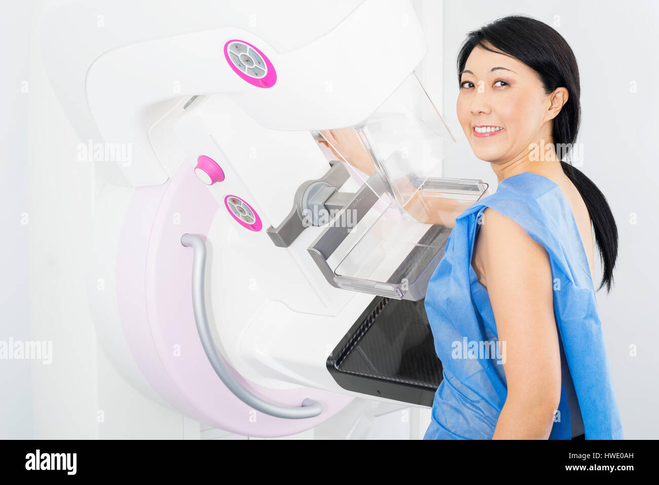 Femme souriante en mammographie examen radiologique Banque D'Images