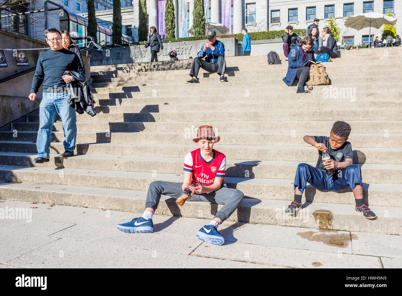 Secouer les garçons de boisson coca cola bouteilles de coca, Vancouver, Colombie-Britannique, Canada. Banque D'Images