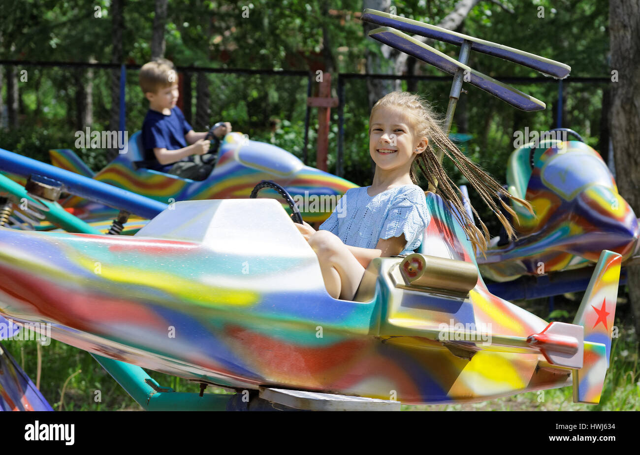 Les enfants, soeur et frère ride sur un jouet avion - une attraction dans le parc Banque D'Images