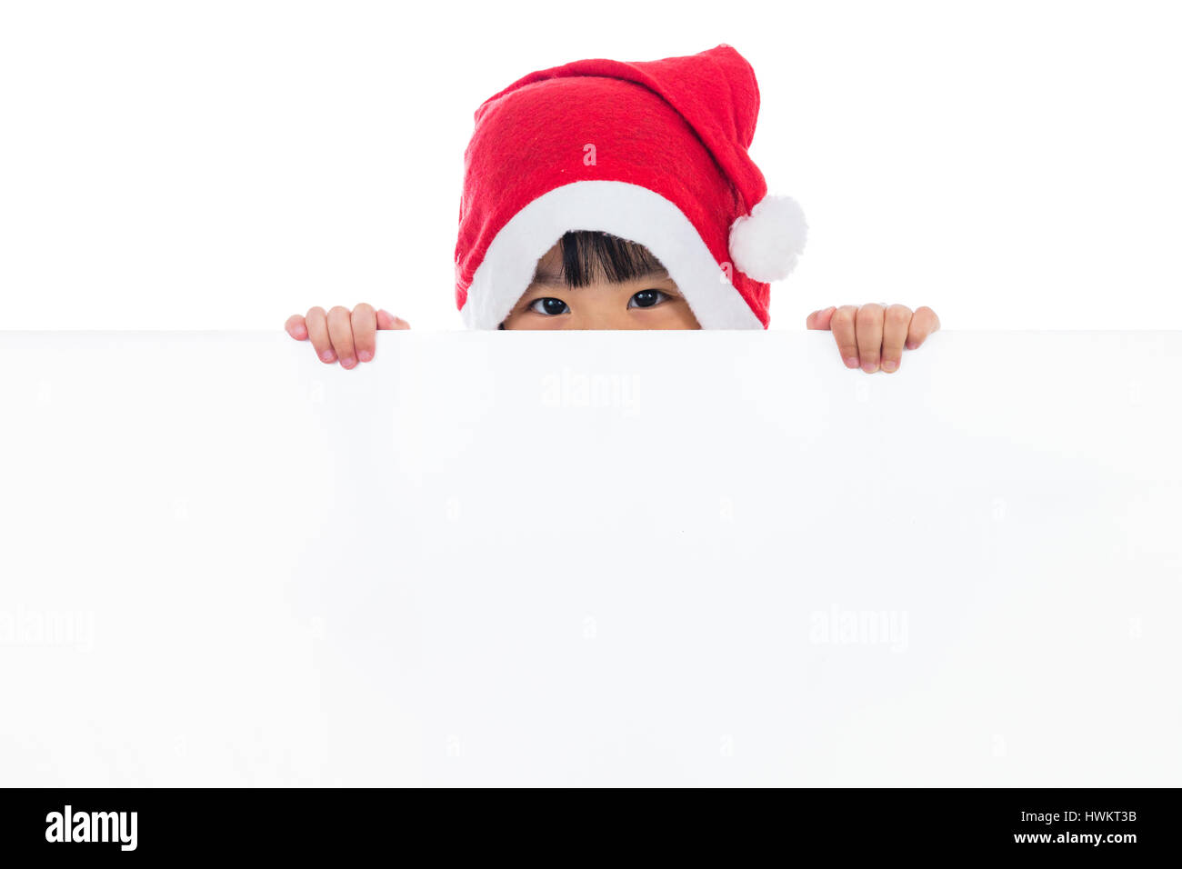 Peu de Chinois asiatique santa girl peeking derrière blank board en fond wihte isolés. Banque D'Images