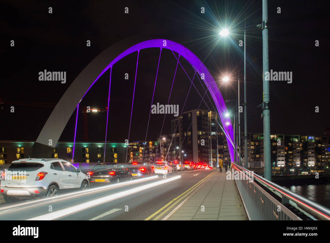 Le Clyde Arc (connu localement comme le Pont aux) - la circulation et les piétons traversant la rivière Clyde dans la nuit Banque D'Images