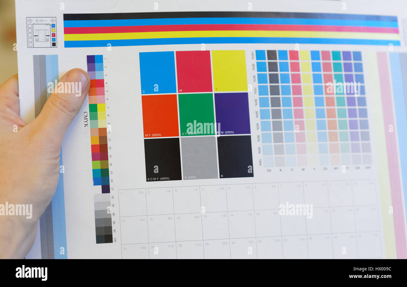 Main tenant un test d'impression en couleur pour l'inspection dans l'atelier d'impression Banque D'Images
