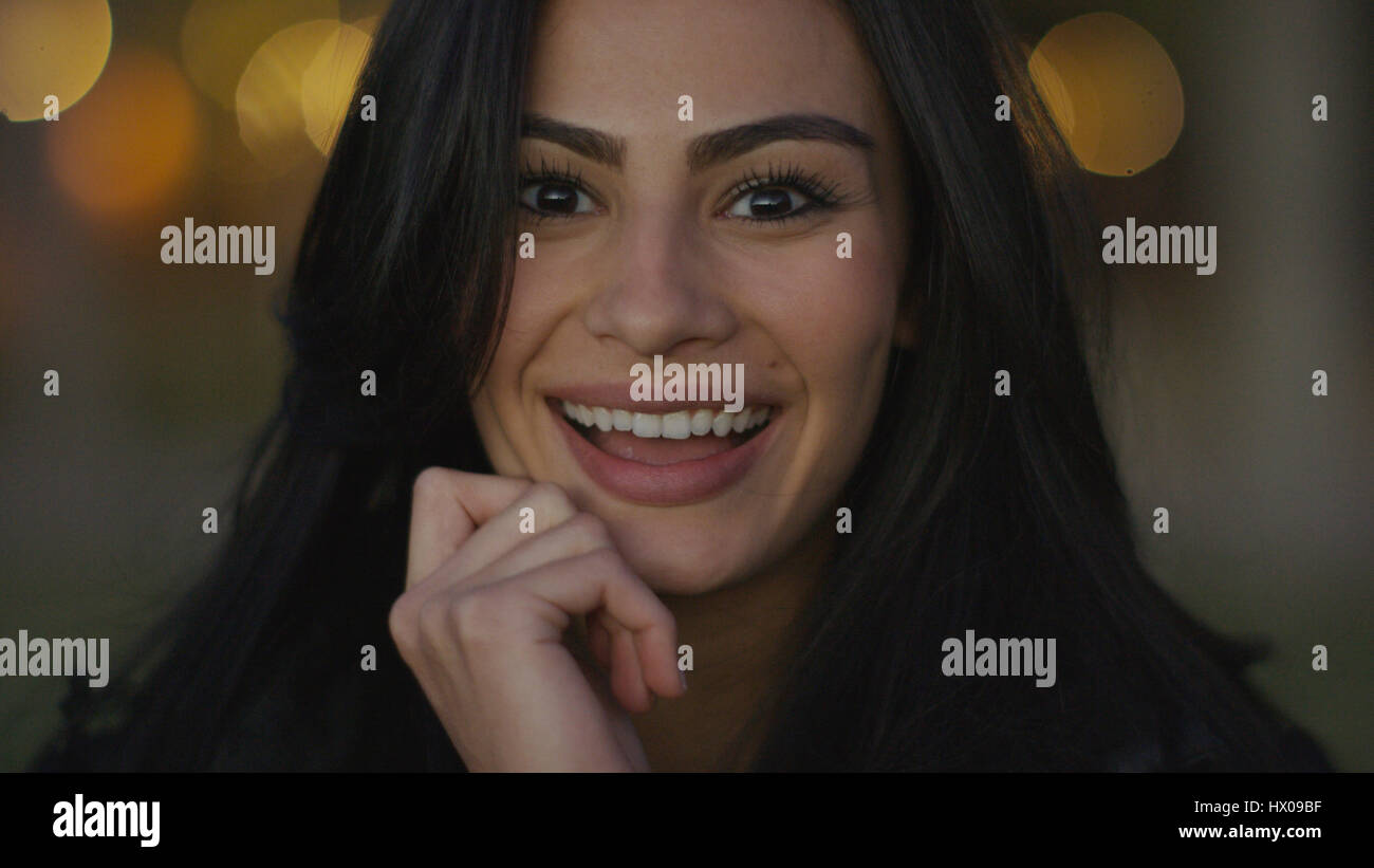 Close up portrait of smiling woman touching her chin Banque D'Images