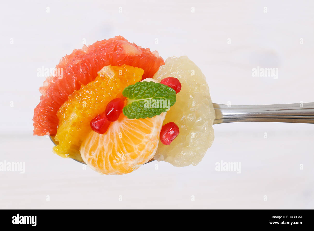 Cuillère à soupe de salade de fruits sur fond blanc Banque D'Images