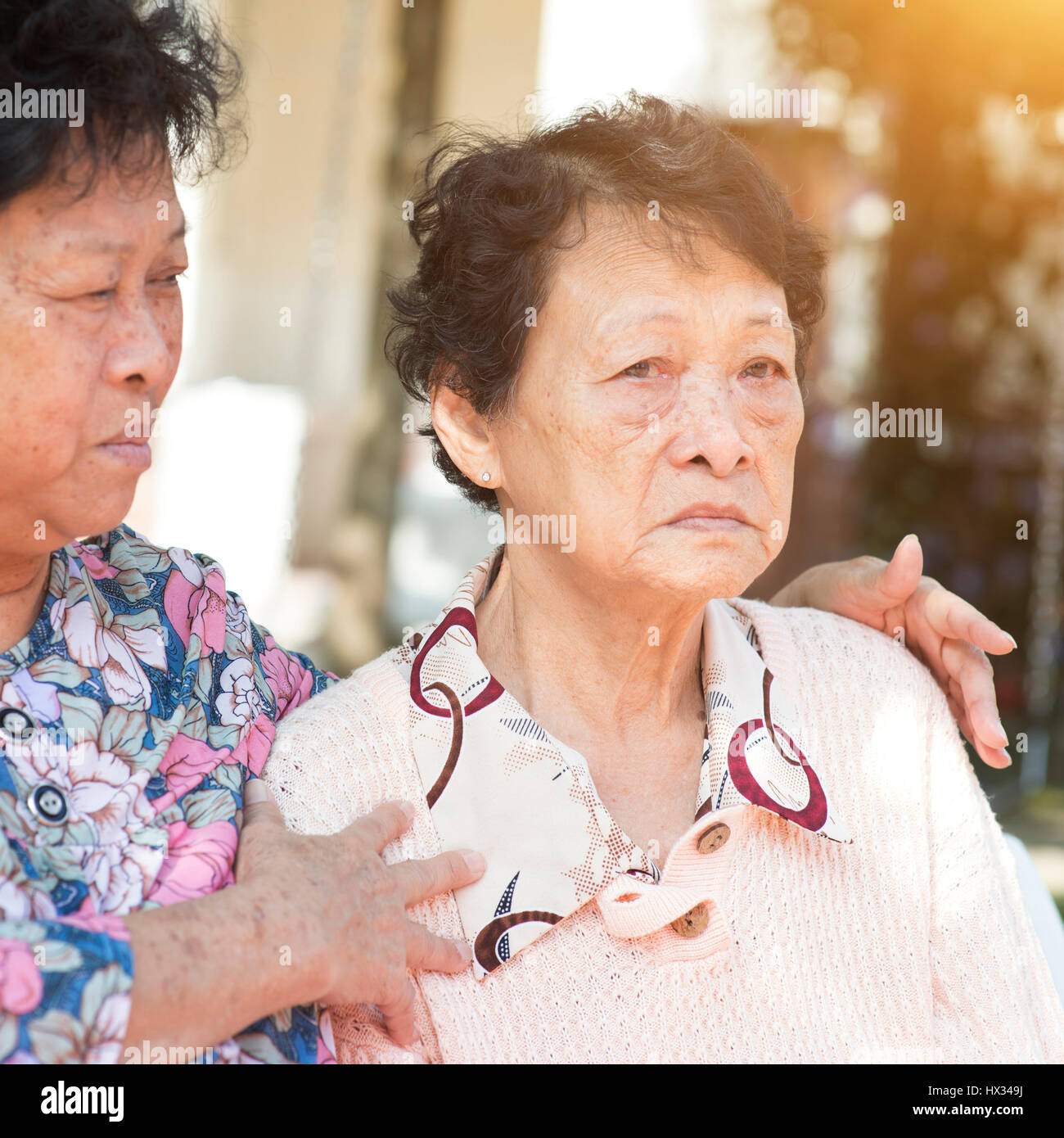 Candid shot of Asian femmes âgées chit chatting at outdoor park le matin. Banque D'Images