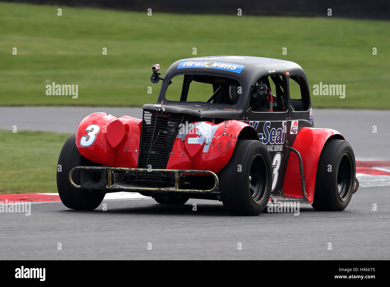 Mike Schlup arrondissement clearways coin au circuit automobile de Brands Hatch dans ses légendes Ford 34 Coupé, à l'avant plan Banque D'Images