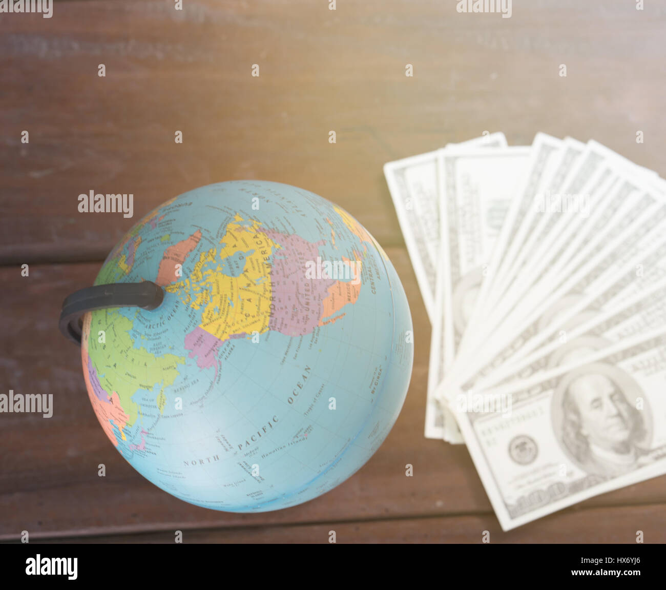 Globe avec dollar bill on wooden table Banque D'Images