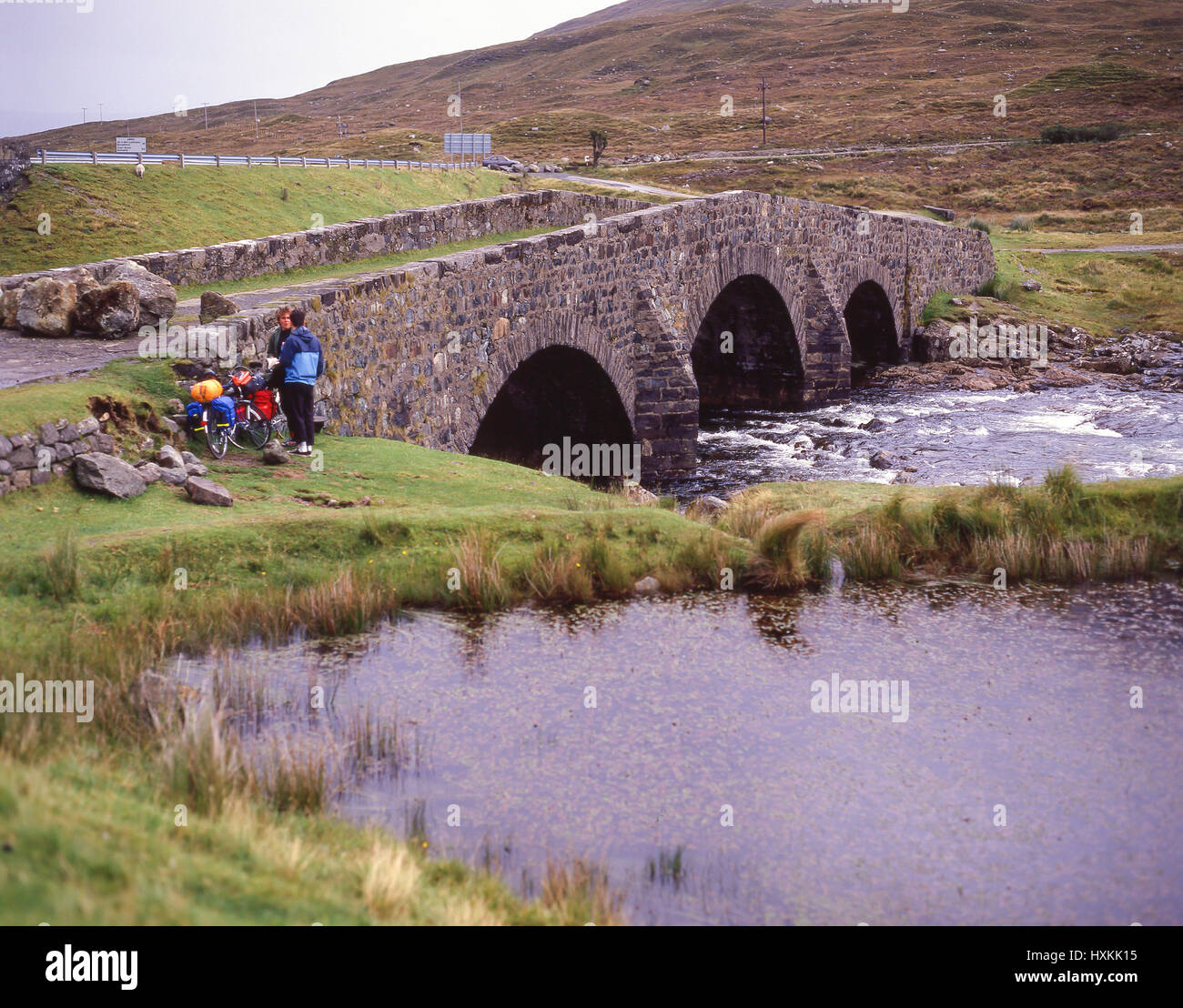 Les cyclistes par pont de pierre, l'île de Skye, Hébrides intérieures, Highland, Ecosse, Royaume-Uni Banque D'Images