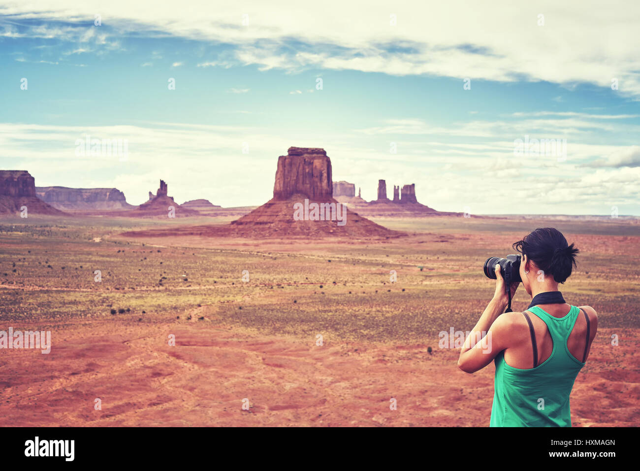 Tons vintage photo de femme photographe fit prend des photos de buttes dans le Monument Valley, USA. Banque D'Images