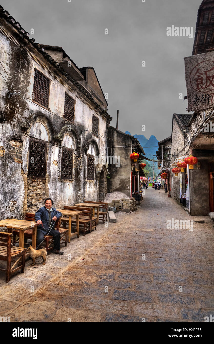 Village de Xinping, Yangshuo, Guangxi, Chine - le 29 mars 2010 : Ancienne ville, attraction touristique, dans la rue étroite avec des lanternes chinoises pour café en plein air Banque D'Images