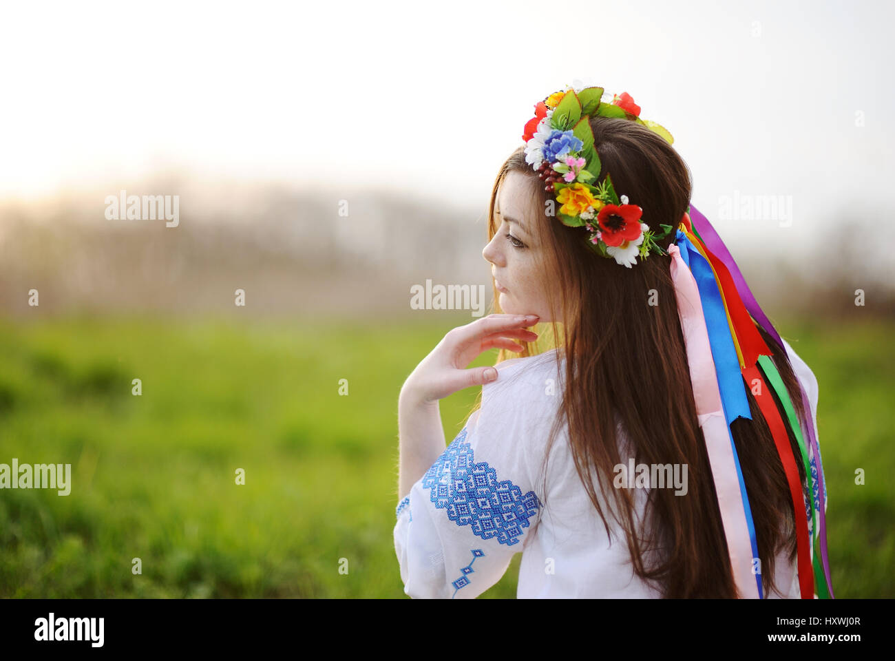 Jeune fille ukrainienne dans une chemise et une gerbe de fleurs sur sa tête sur un b Banque D'Images