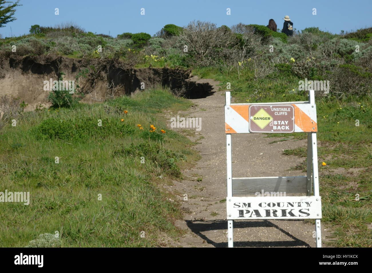 Met en garde les randonneurs du sentier inscription coupés par l'érosion des vagues Banque D'Images