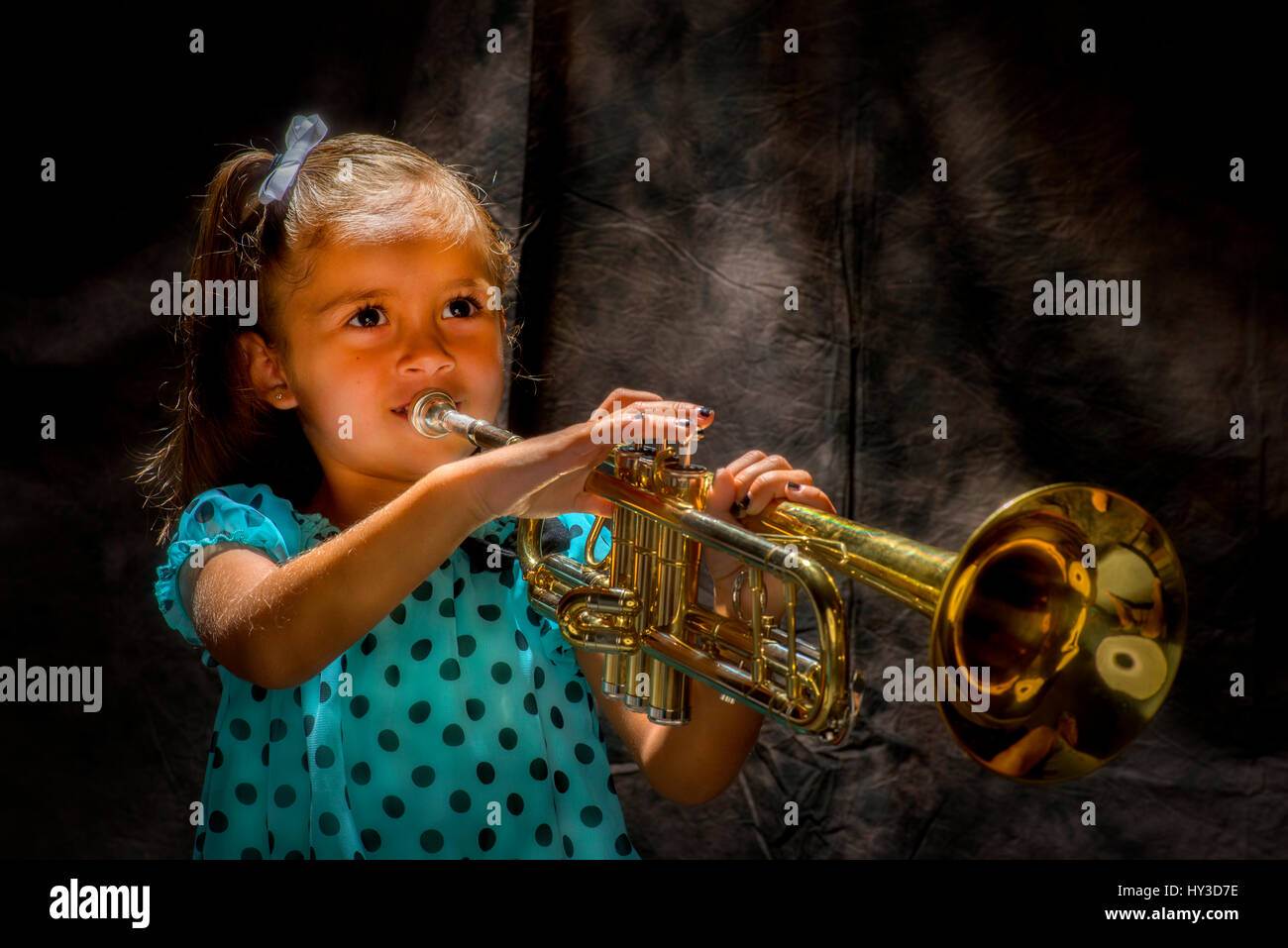 Jeune fille jouant avec corne Banque D'Images