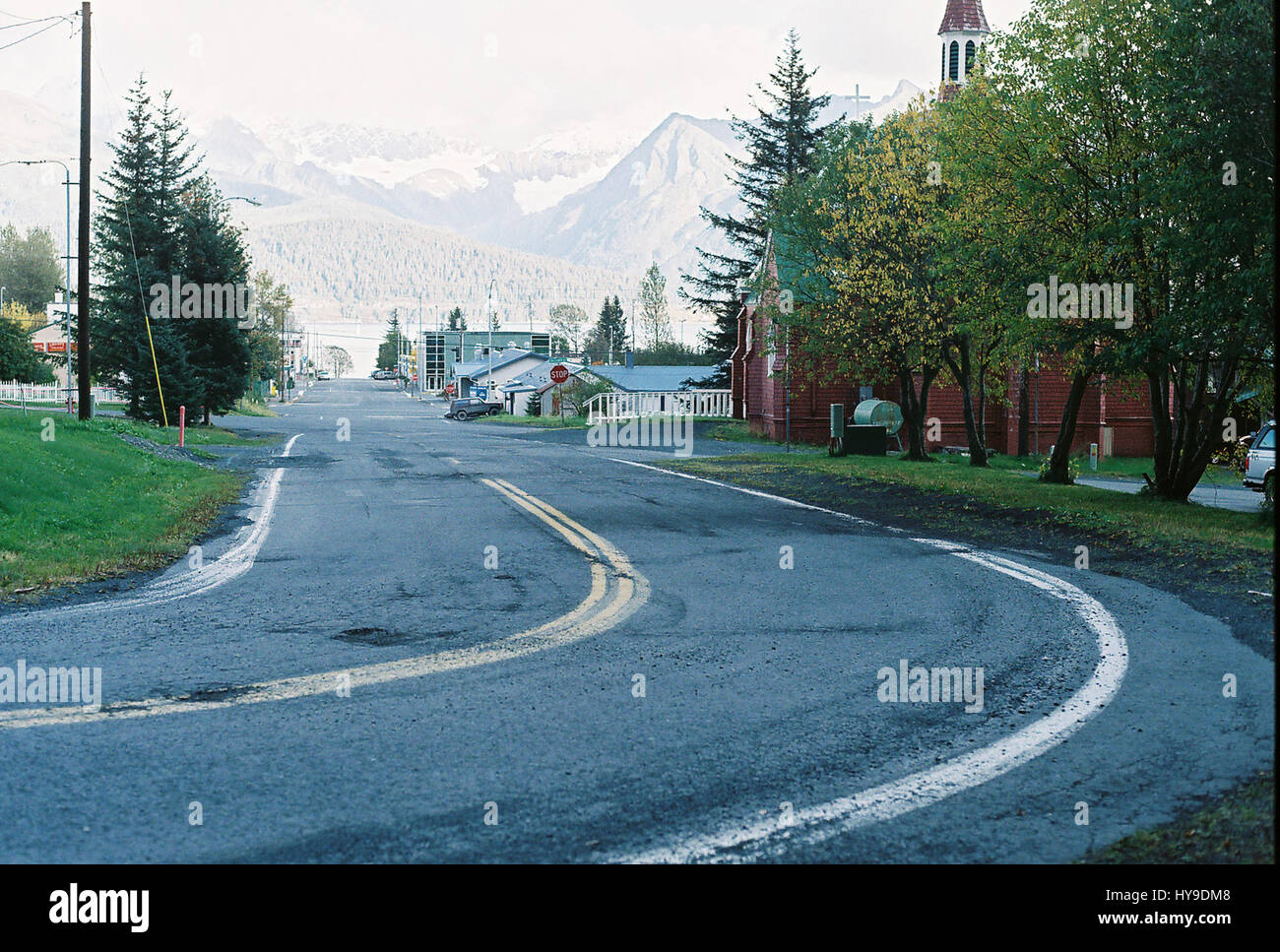 Un virage de la route avec des montagnes en arrière-plan de la ville de Seward, en Alaska. Banque D'Images