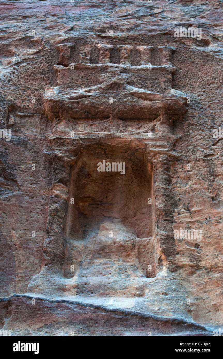 Jordanie : niche votive sur la roche rouge vu marcher dans le canyon de la Siq, l'arbre, l'entrée principale de la ville nabatéenne de Pétra archéologique Banque D'Images