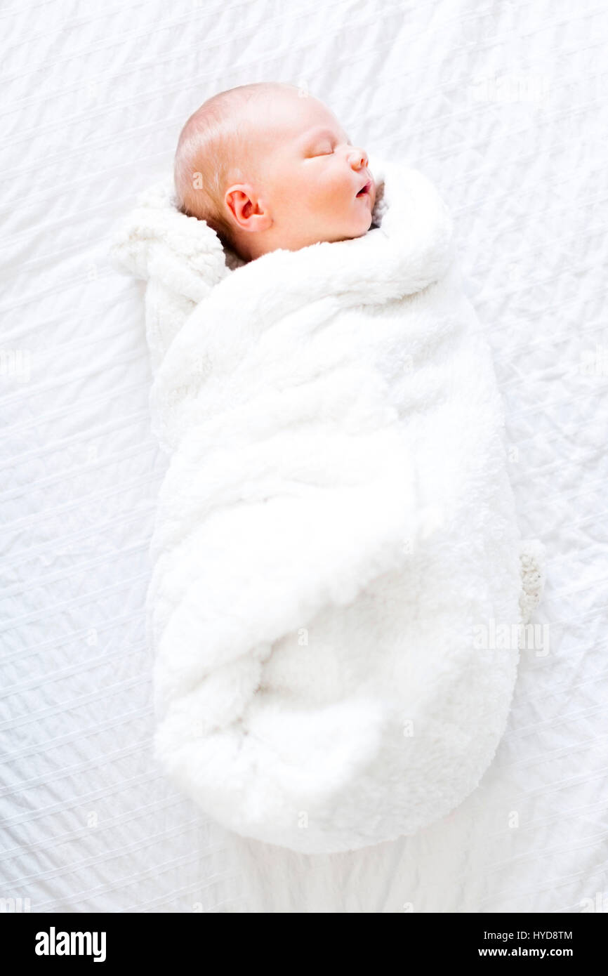 Bébé garçon (2-5 mois) dormant dans une couverture blanche Banque D'Images
