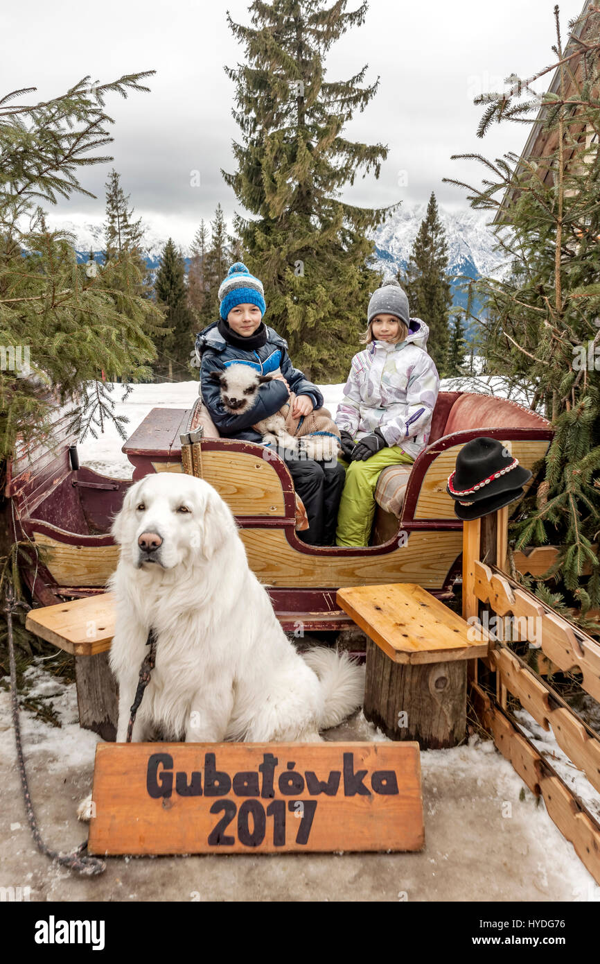 Les enfants avec de l'agneau et le chien qui pose pour photo à la montagne Gubalowka, Pologne Banque D'Images