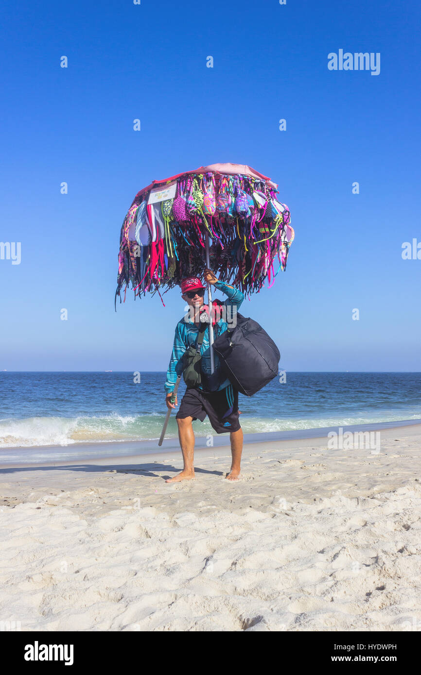 Brésil, Rio de Janeiro : Man selling bikinis sur la plage de Copacabana Banque D'Images