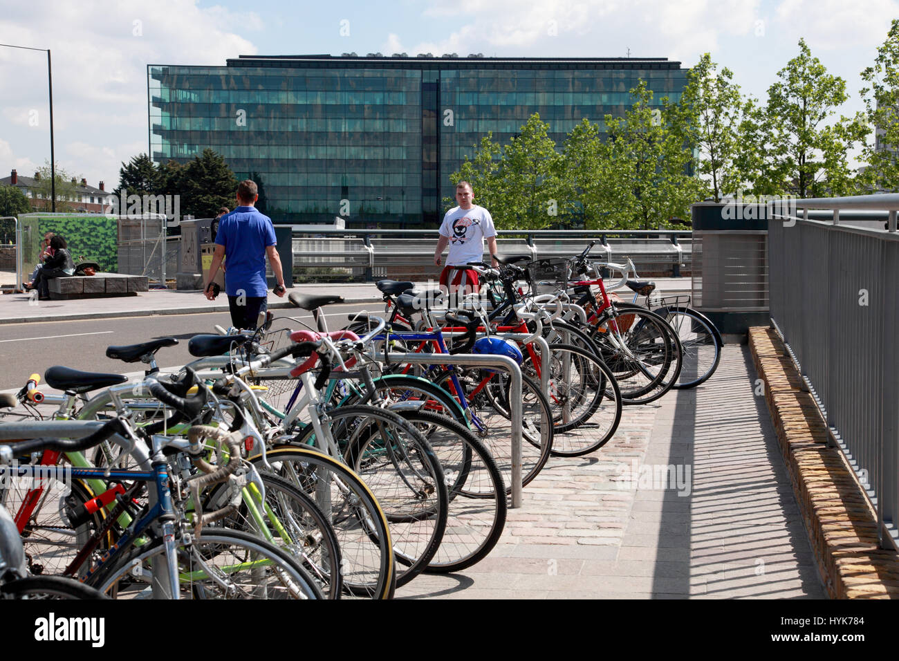 Prêt de vélos garés dans le grenier Square par Regent's Canal, King's Cross, en regardant vers l'immeuble de verre, plaqué Kings Place, Londres Banque D'Images