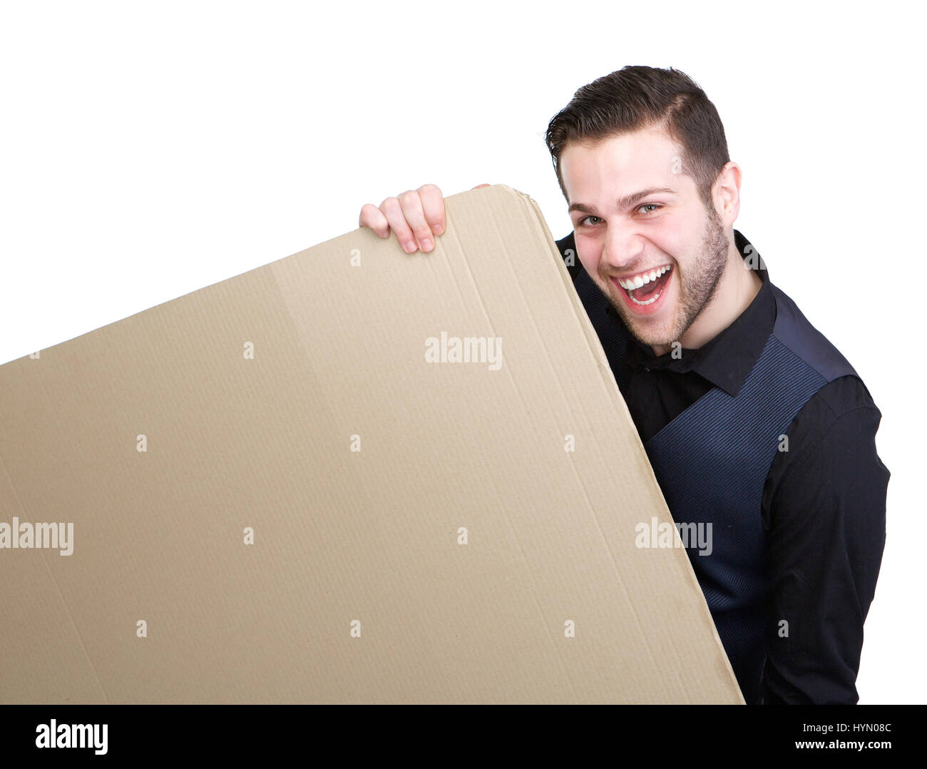 Portrait of a handsome young man smiling and holding empty enseigne-affiche isolées sur fond blanc Banque D'Images