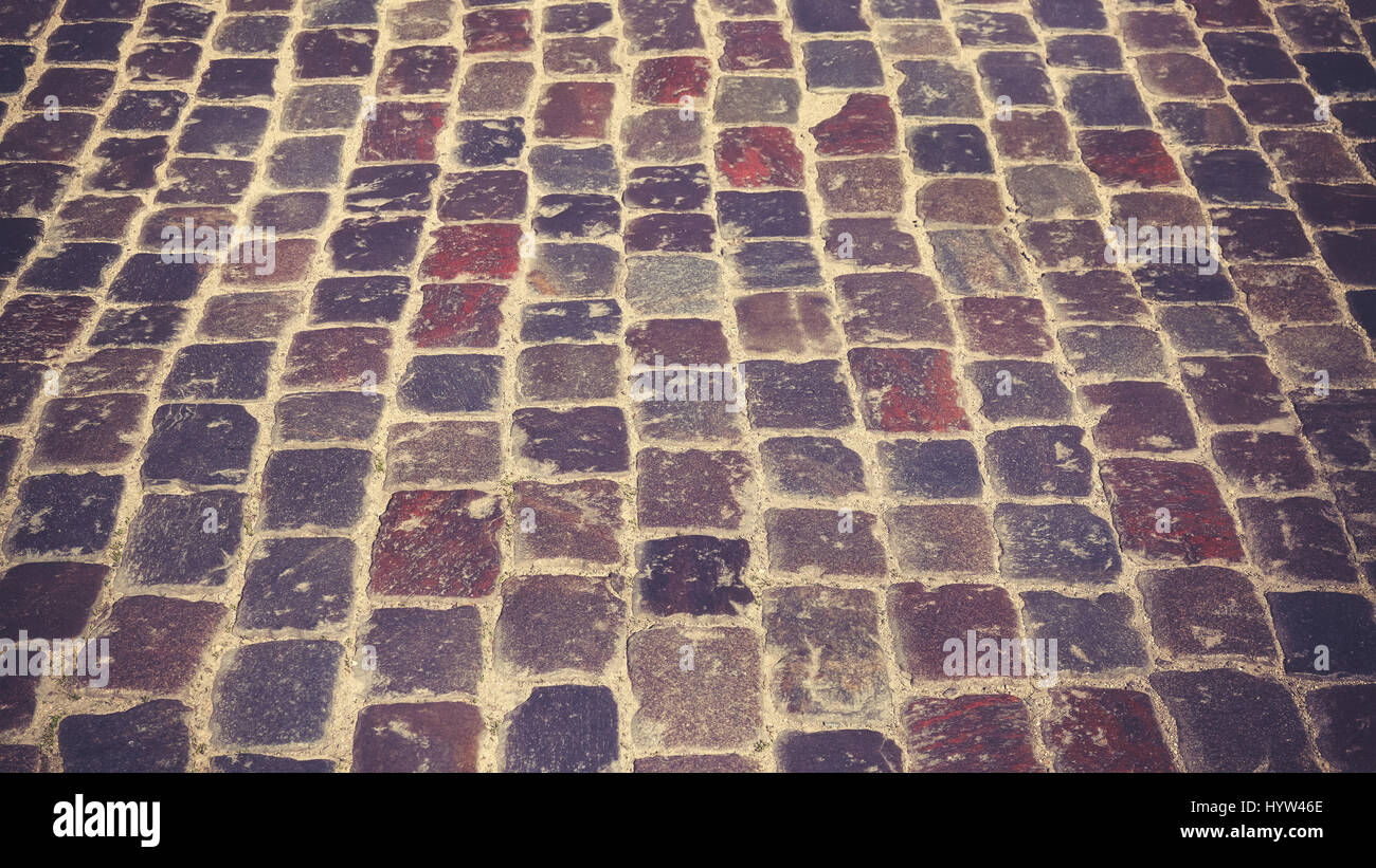 Les tons de couleur petite rue pavée, l'arrière-plan ou de texture, selective focus. Banque D'Images