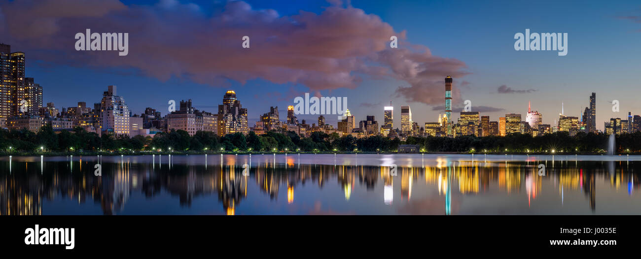 Vue panoramique sur le réservoir de Central Park et les gratte-ciel de Midtown allumé au crépuscule en été. Manhattan, New York City Banque D'Images
