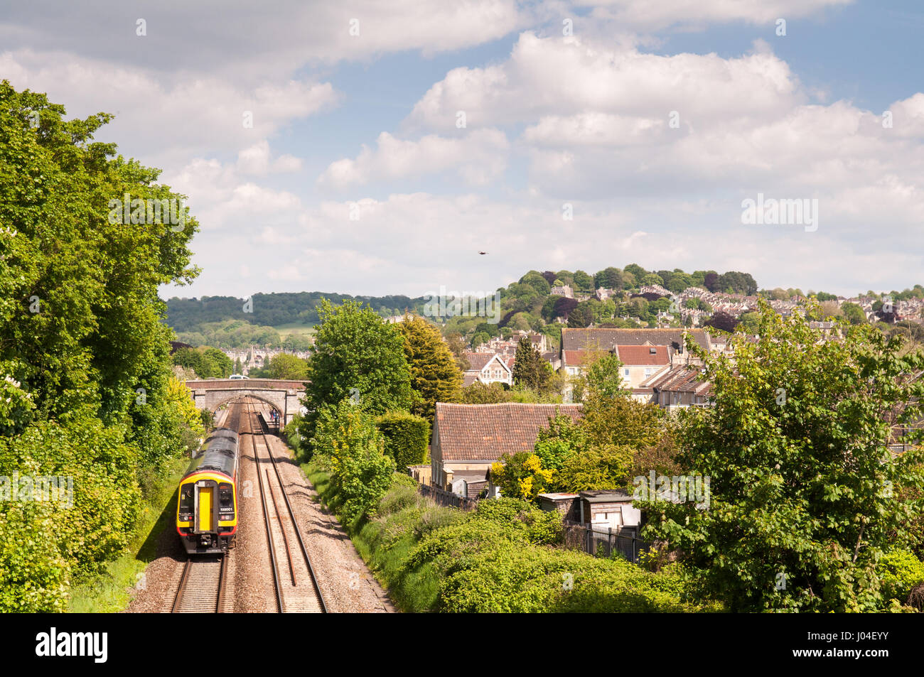 Bath, Angleterre, Royaume-Uni - 25 mai 2013 : une Première Classe 158 Great Western Railway train voyageurs diesel régional voyages passé des maisons dans la banlieue de baignoire. Banque D'Images