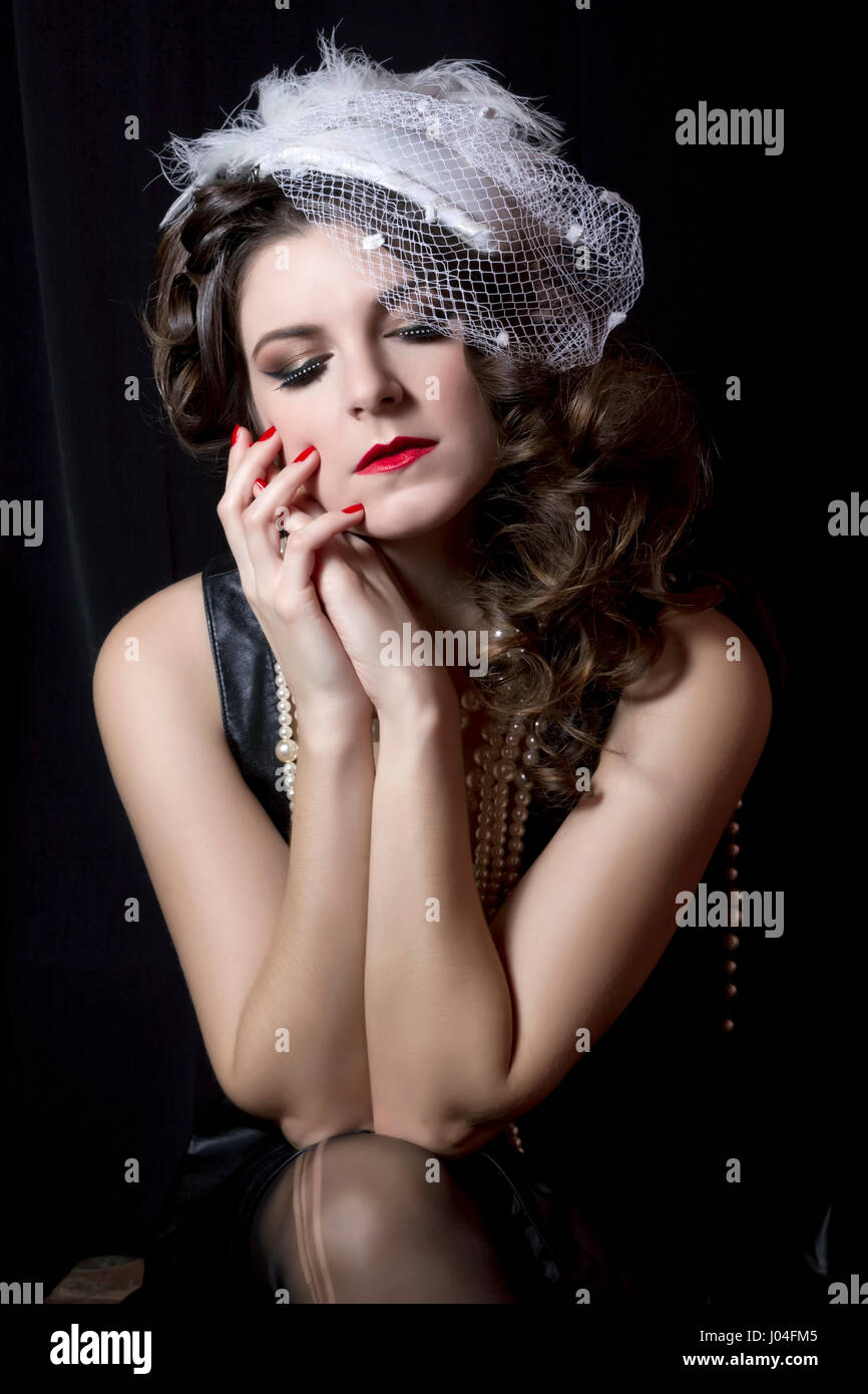 Belle coiffure vintage avec un chapeau blanc. La photographie de studio  Photo Stock - Alamy