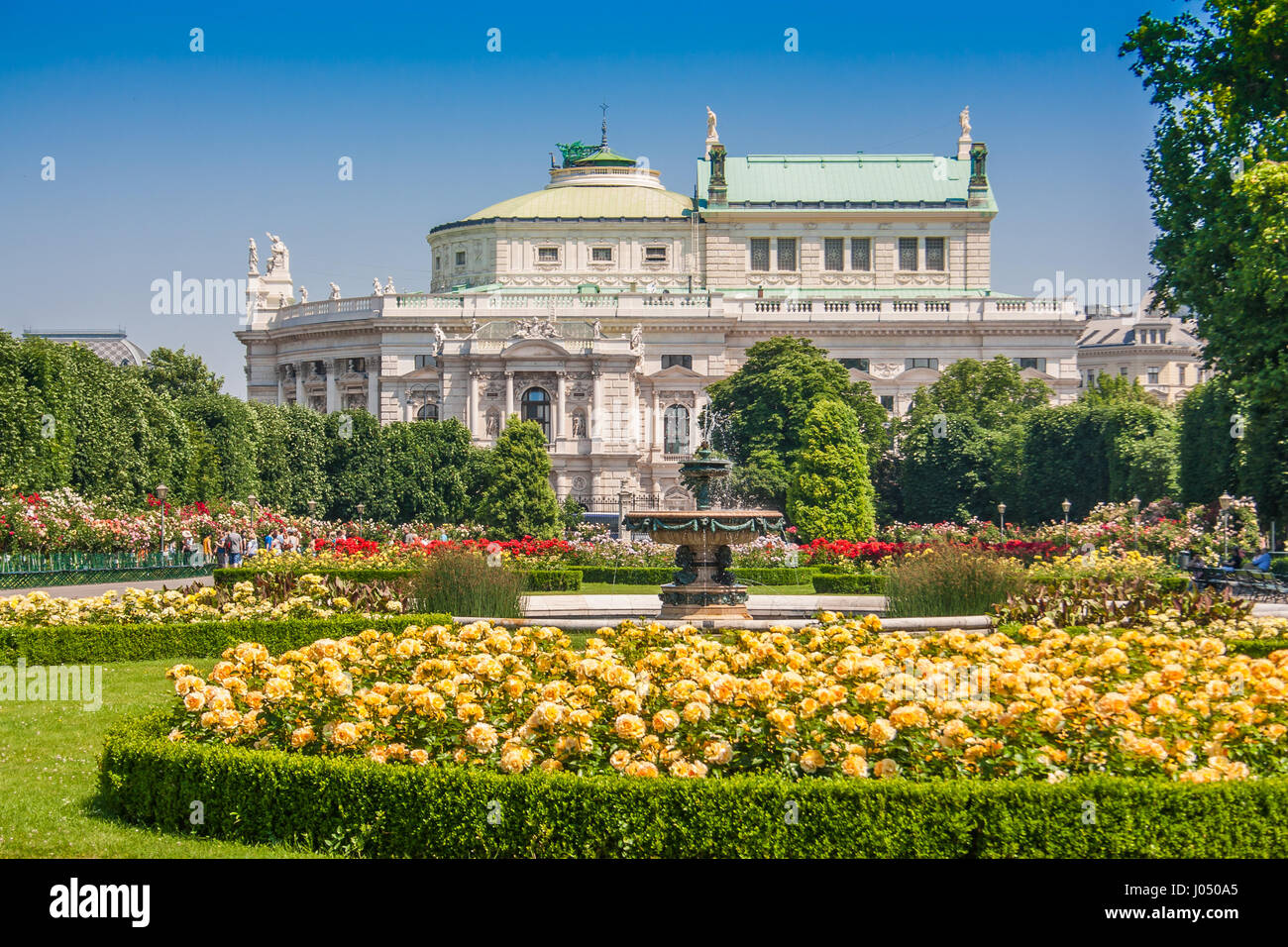 Belle vue sur la célèbre Volksgarten (jardin) parc public avec Burgtheater historique dans l'arrière-plan en été, Vienne, Autriche Banque D'Images