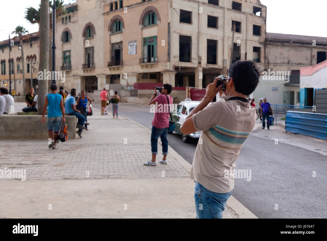 Les touristes de prendre des photos le long du Malecon dans la Vieille Havane, Cuba. Banque D'Images