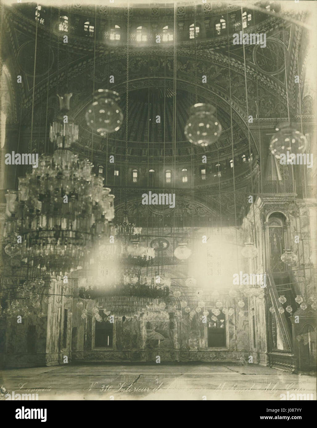 Cette photographie de Zangaki capture l'intérieur de la mosquée Mehemet Aly au Caire, mettant en valeur l'architecture islamique, les conceptions complexes et l'importance culturelle et religieuse de la mosquée en Égypte. Banque D'Images