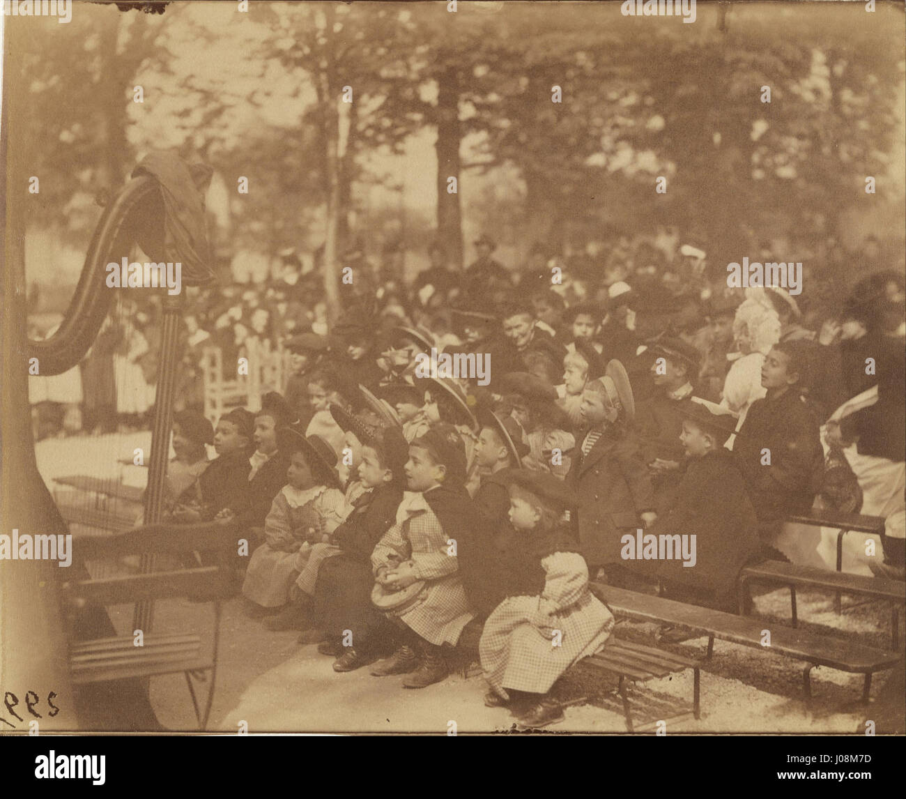 La photographie d’Eugène Atget de Guignol dans le jardin du Luxembourg capture un moment dans l’emblématique jardin parisien. Guignol, le célèbre personnage de marionnette, est représenté dans un cadre décontracté, reflétant l’accent mis par Atget sur la documentation de la vie quotidienne à Paris au début du XXe siècle. Banque D'Images