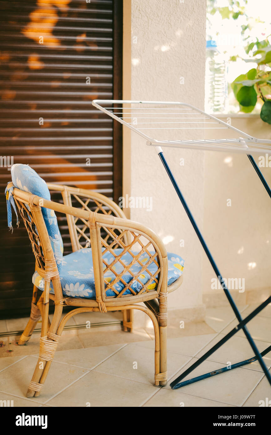 Wicker Chair avec un coussin bleu Banque D'Images