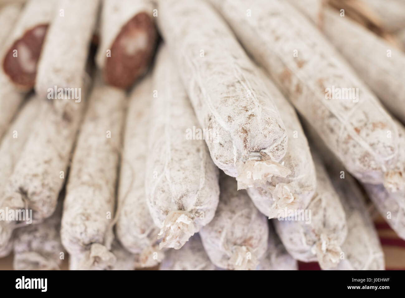 Ensemble et les tranches de salami heap sur étagère du marché, selective focus Banque D'Images