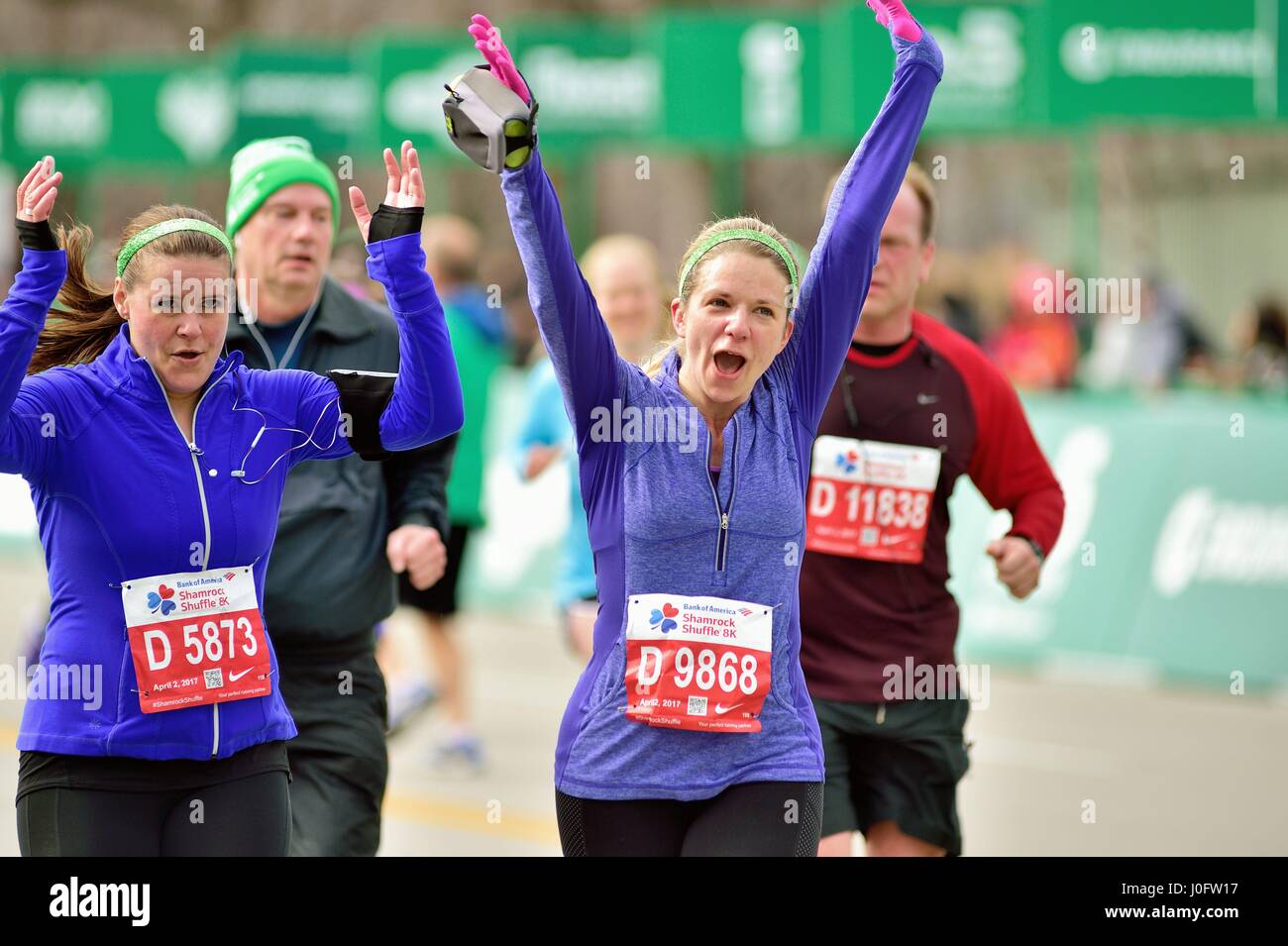 Coureur très heureux de franchir la ligne d'arrivée lors de la course 2017 Shamrock Shuffle à Chicago, Illinois, USA. Banque D'Images