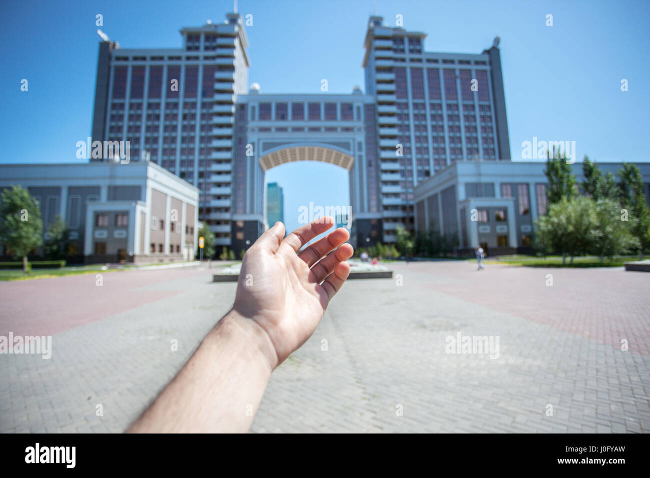 Main sur le siège social de l'arrière-plan, KazMunaiGas situé dans capitale du Kazakhstan. Entreprise est engagée dans la production et la réalisation de pétrole et de gaz. Banque D'Images