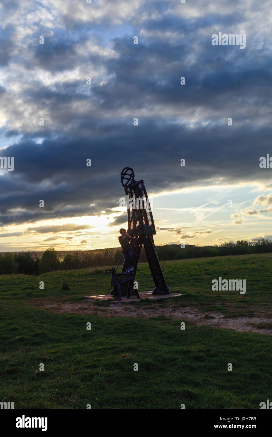 Hucknall, Nottinghamshire, Angleterre. 13 avr, 2017. Coucher de soleil sur les plages Country Park près de la ville de marché de Hucknall. Coucher de soleil derrière le chien-walker la sculpture. Crédit : Ian Francis/Alamy Live News Banque D'Images