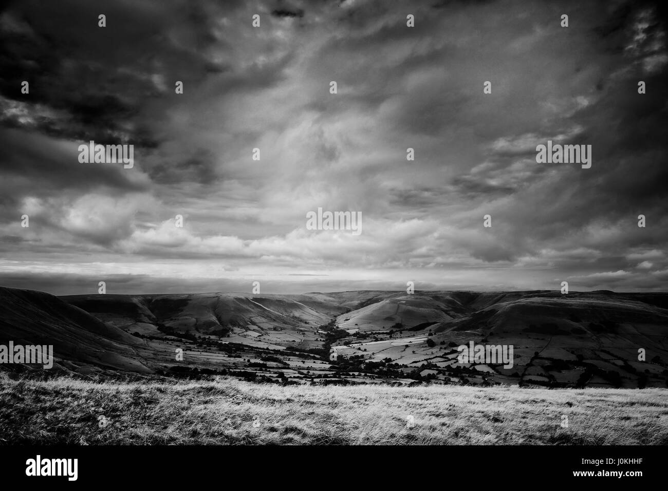 Une majestueuse moody sky ombre & lumière formes modes sur une colline sombre dans le Peak District. Banque D'Images