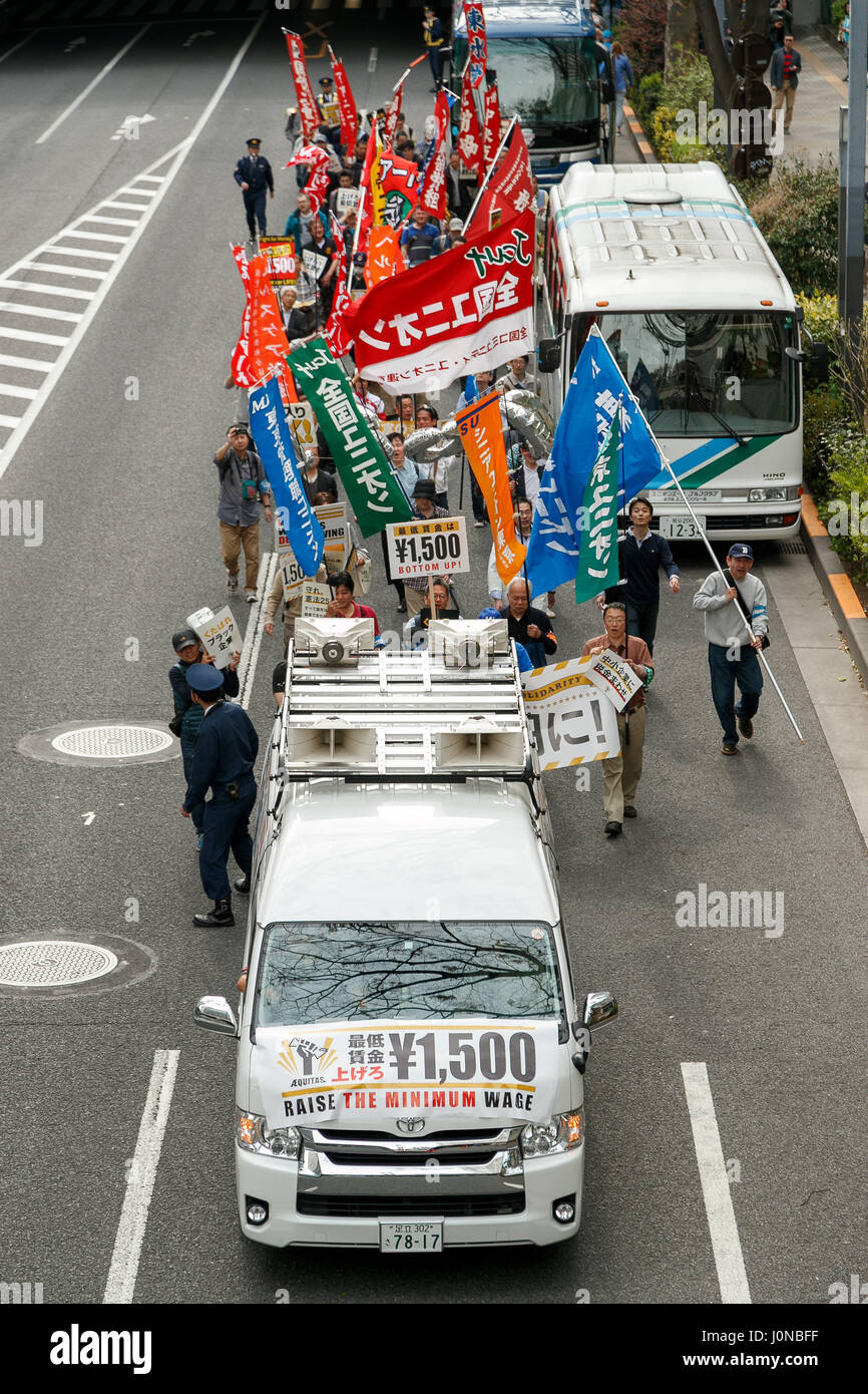 Tokyo, Japon. 15 avril, 2017. Les manifestants tiennent des pancartes exigeant des hausses de salaires et de meilleures conditions de travail au cours d'un rassemblement dans le quartier Shinjuku de Tokyo le 15 avril 2017, au Japon. Les membres du groupe activiste AEQUITAS, qui signifie ''justice'' en latin, exigent un salaire horaire minimum de 1 500 JPY (env. USD 13.81.) La marche a débuté devant le bâtiment du Gouvernement Métropolitain de Tokyo et passé à travers Shinjuku. Credit : Rodrigo Reyes Marin/AFLO/Alamy Live News Banque D'Images
