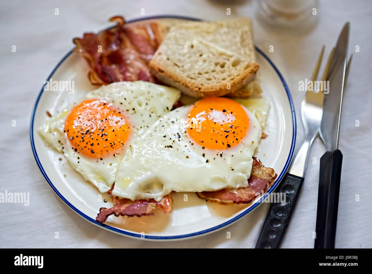 Des œufs sur le lard avec petit-déjeuner, pain, plaque blanche Banque D'Images