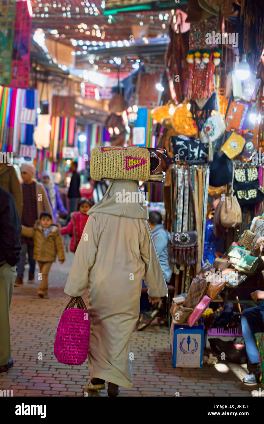 Retour d'un homme portant sur sa tête dans un sac de marché de Marrakech, Maroc (zone centre-ville Banque D'Images