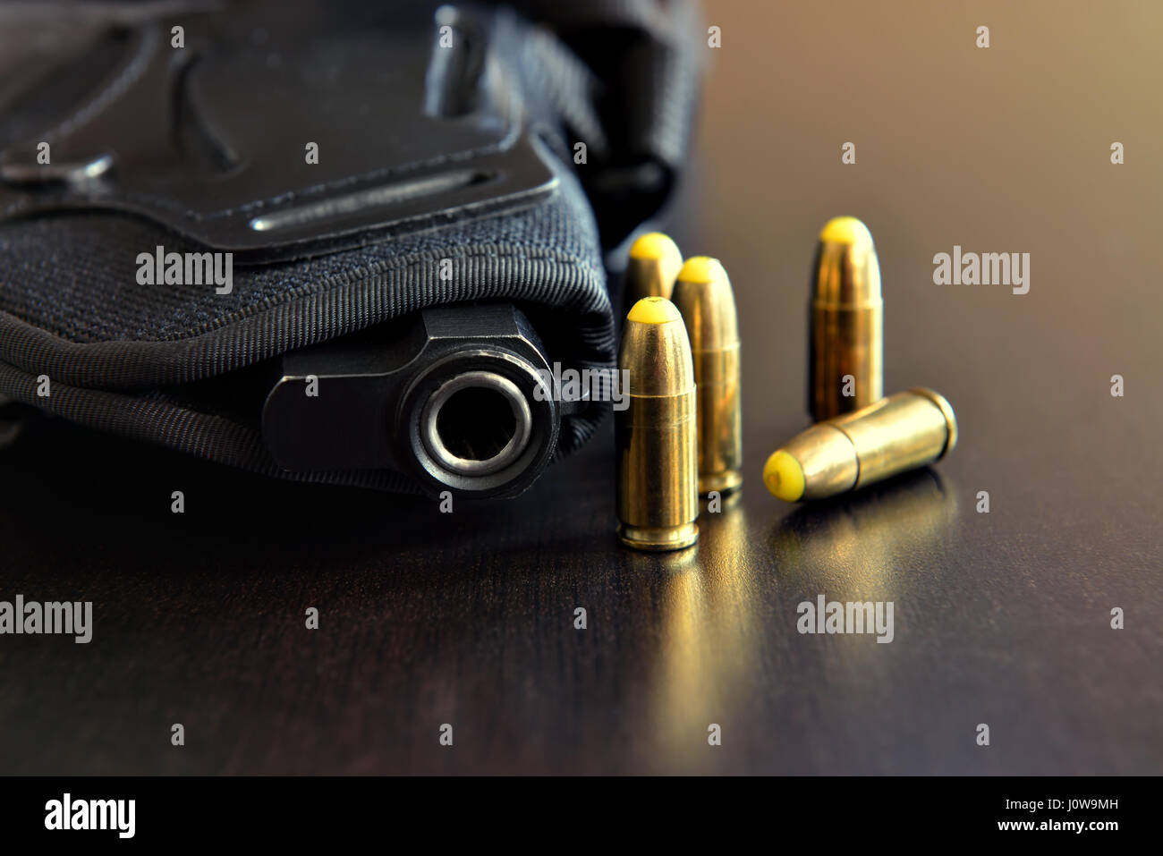 Pistolet en étui noir et des balles sur tableau noir Banque D'Images