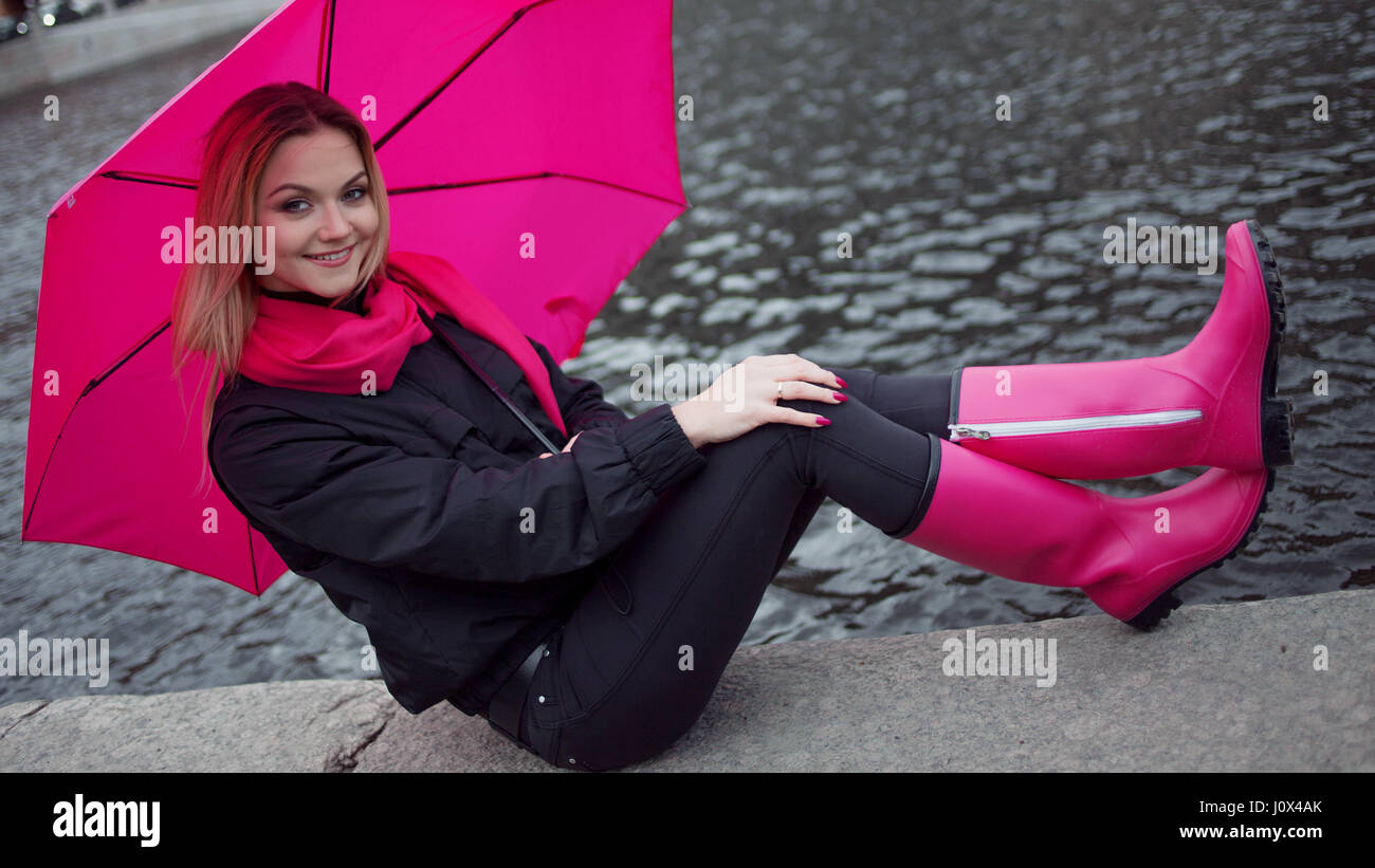 Très belle jeune femme blonde et heureuse avec parapluie colorés sur la rue. La notion de positivité et d'optimisme Banque D'Images