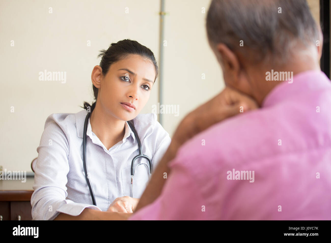 Closeup portrait, patient talking conversation sérieuse à votre professionnel des soins de santé, à l'intérieur isolé background Banque D'Images