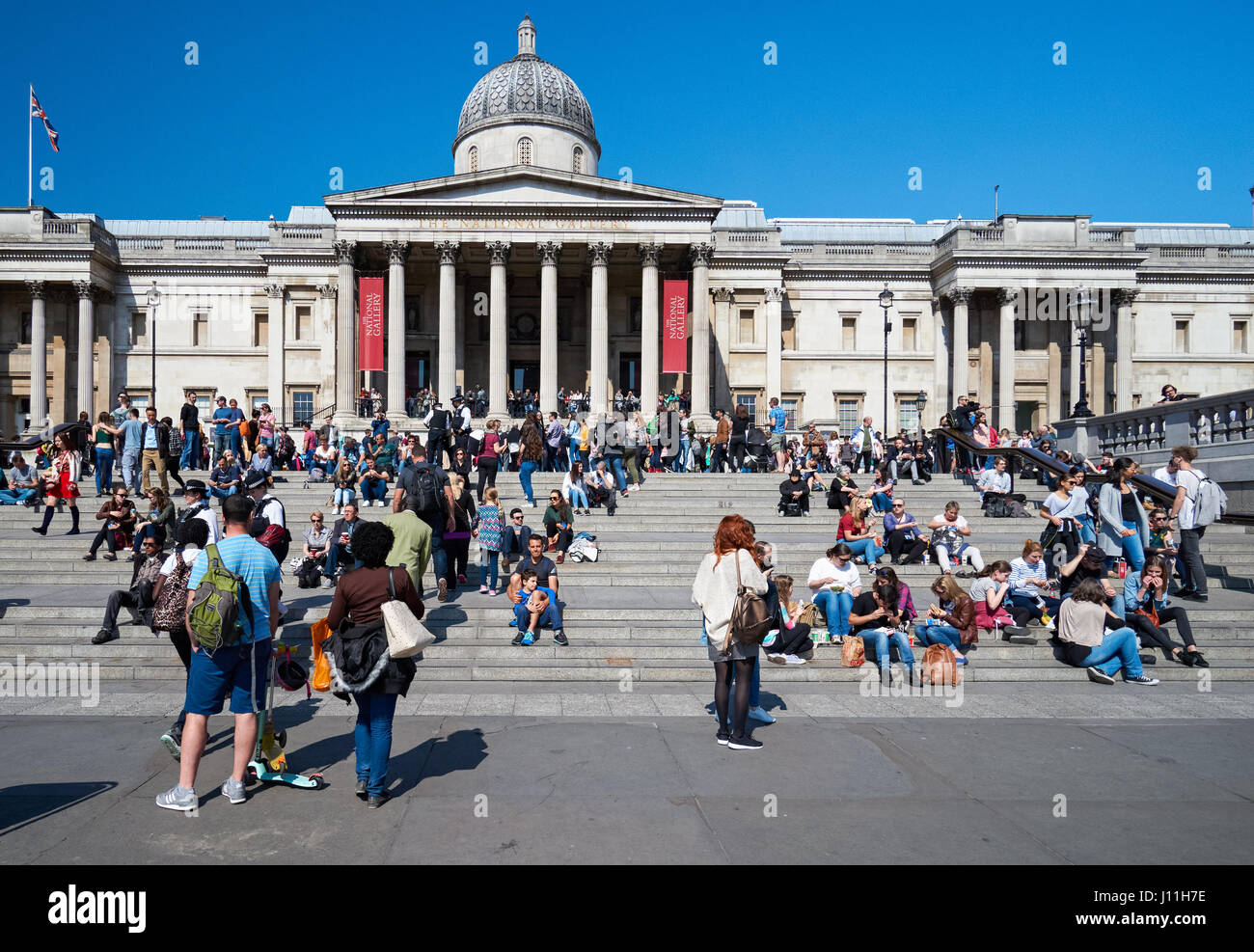 Les touristes en dehors de la National Gallery à Trafalgar Square, Londres, Angleterre Royaume-Uni UK Banque D'Images