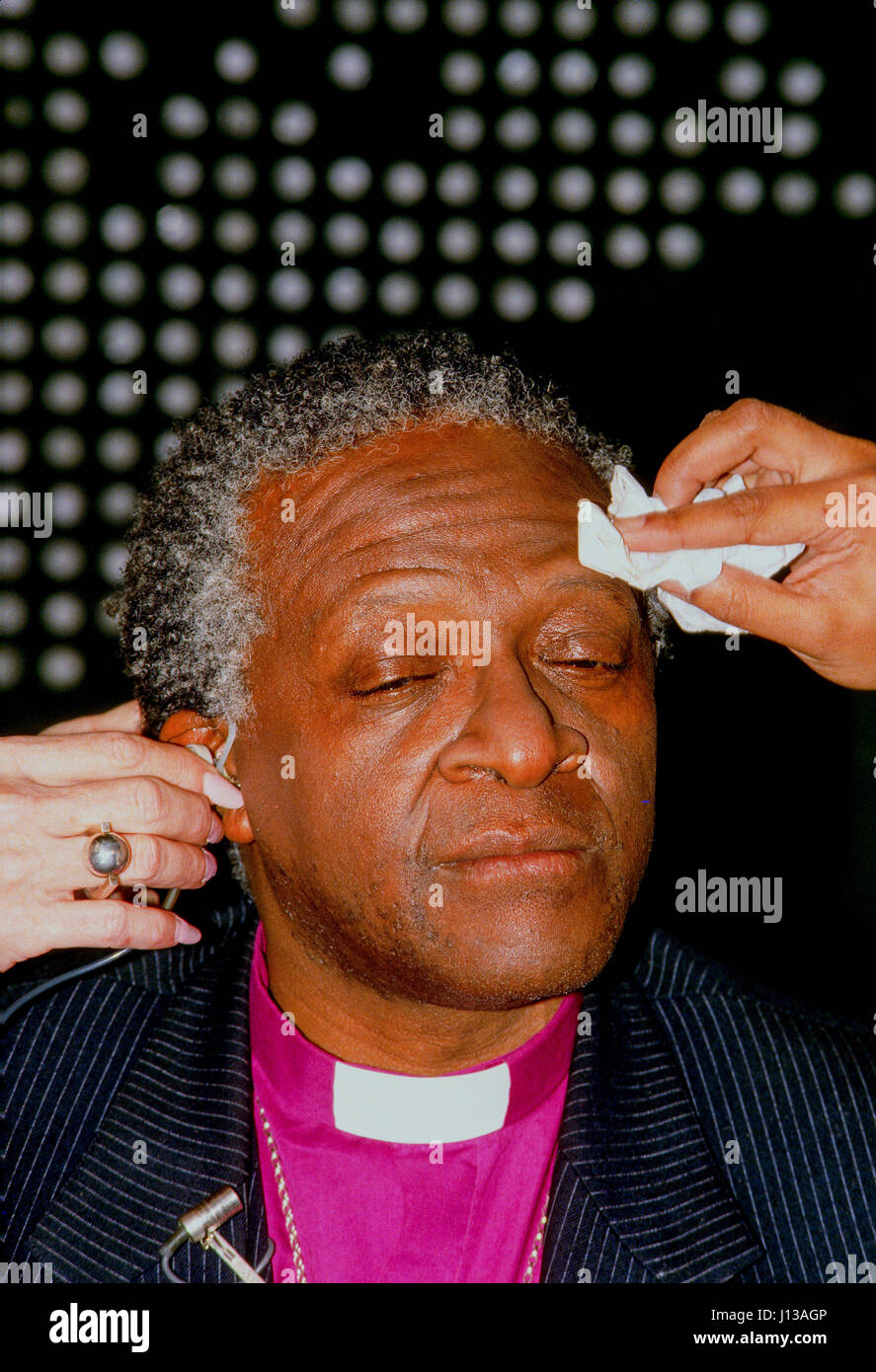 L'évêque Desmond Tutu devient un miroir appliqué à sa face avant sa première apparition sur le câble CNN News Salon "Larry King live" de Washington DC., juillet, 1985. Photo par Mark Reinstein Banque D'Images