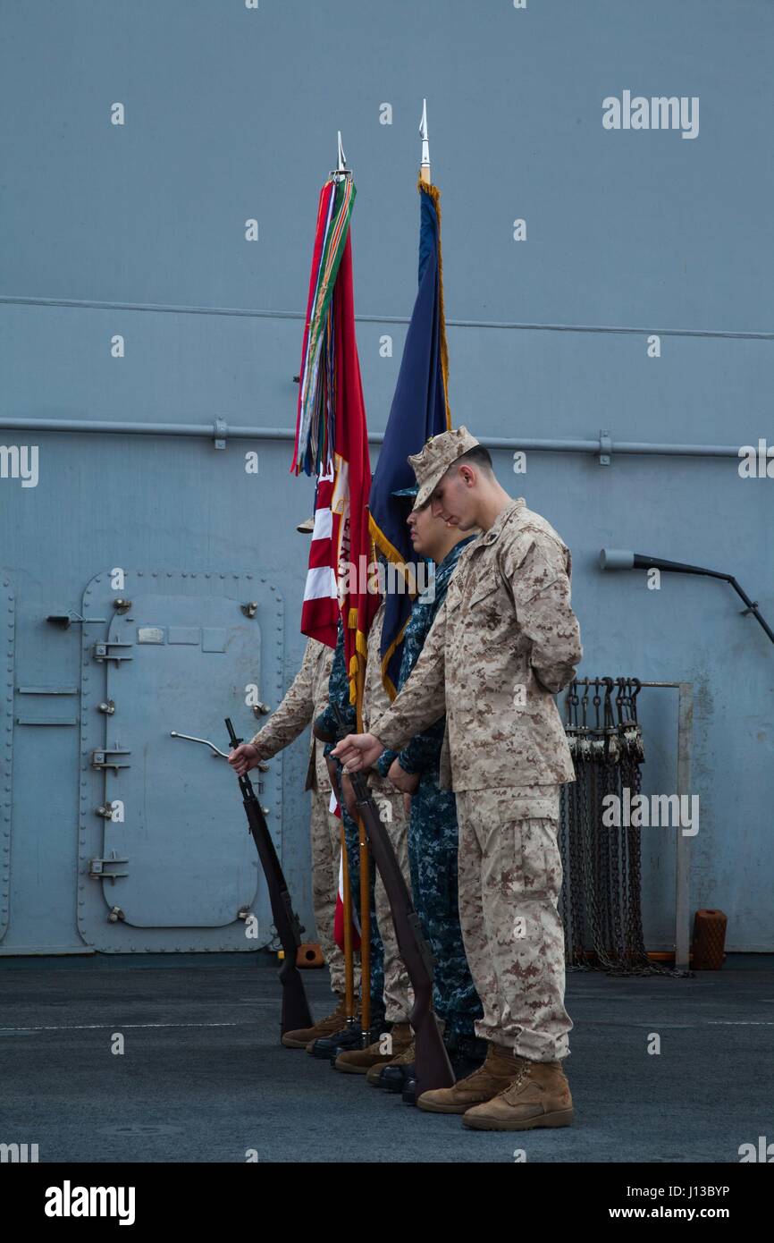 170414-N-OE749-035 GOLFE D'ADEN (14 avril 2017) marins et soldats se préparer à défiler les couleurs pendant le 75e anniversaire de la bataille de Bataan cérémonie du souvenir sur le pont d'envol du navire. La cérémonie a été le dernier événement de la réunion de cinq jours de commémoration en souvenir de la DEUXIÈME GUERRE MONDIALE La bataille de Bataan aux Philippines se sont battus contre les Japonais du 7 janvier 1942 au 9 avril 1942 et le Bataan, 9 avril 1942, lorsque 76 000 prisonniers de guerre ont été forcés de marcher 65 kilomètres dans des conditions horribles au camp O'Donnell. Bataan et son groupe de prêt sont déployés dans la 5e flotte américaine zone d'exploitation Banque D'Images