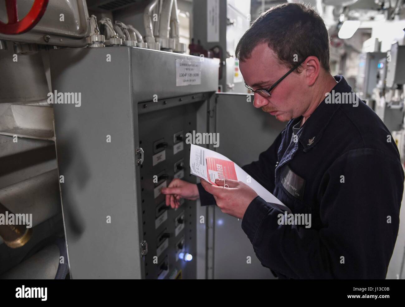 170414-N-RM689-015 Mer de Chine du Sud (14 avril 2017) 3ème classe Technicien en électronique Nicholas Langley, à partir de Miami, renverse un disjoncteur lors d'un tag de maintenance à bord de la classe Arleigh Burke destroyer lance-missiles USS Wayne E. Meyer (DDG 108). Wayne E. Meyer est en fonction d'un programme de déploiement de l'ouest du Pacifique avec le groupe aéronaval du Carl Vinson dans le cadre de la flotte américaine du Pacifique visant à étendre la flotte des États-Unis 3e fonctions de commandement et de contrôle dans l'Indo-Asia-région du Pacifique. Porte-avions de la marine américaine ont régulièrement des groupes grève patrouillé les Indo-Asia-pacifique pour plus de t Banque D'Images